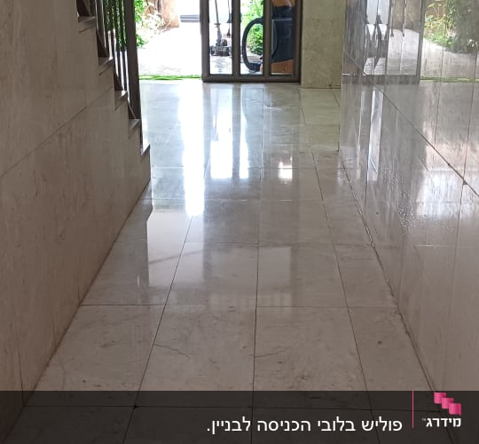 מסדרון עם רצפה נקייה ומבריקה, דלי ומגב ליד הדלת